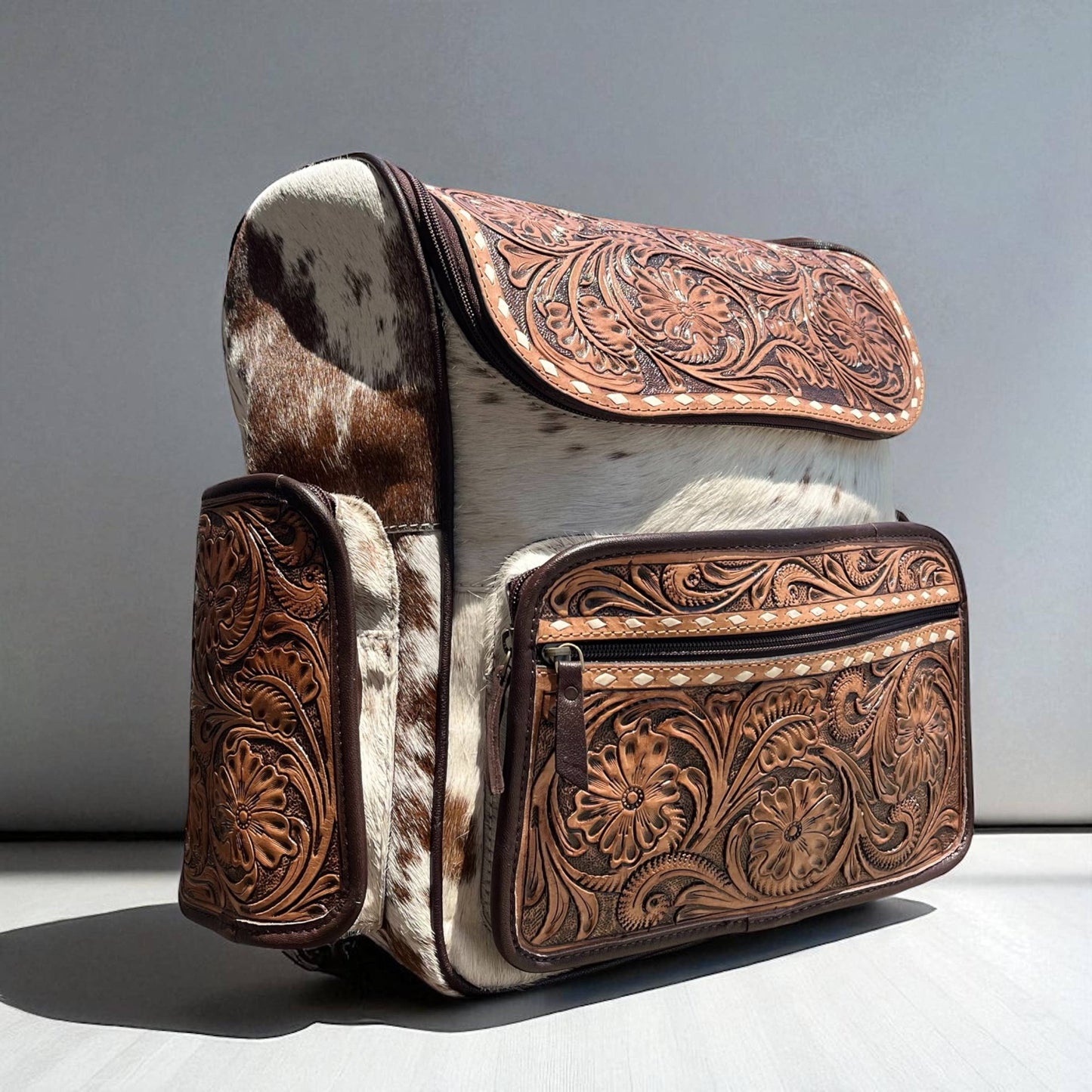 Brown tooled leather & cowhide backpack
